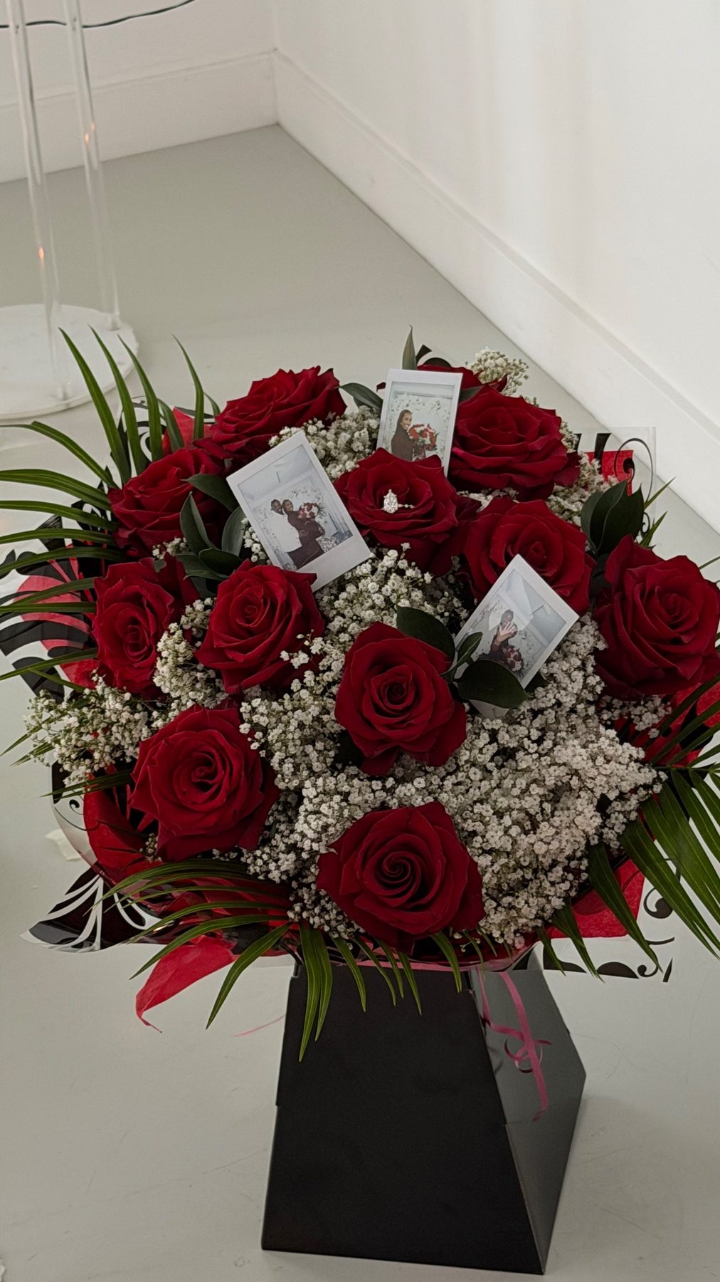 Bouquet of red roses and baby's breath in a black box