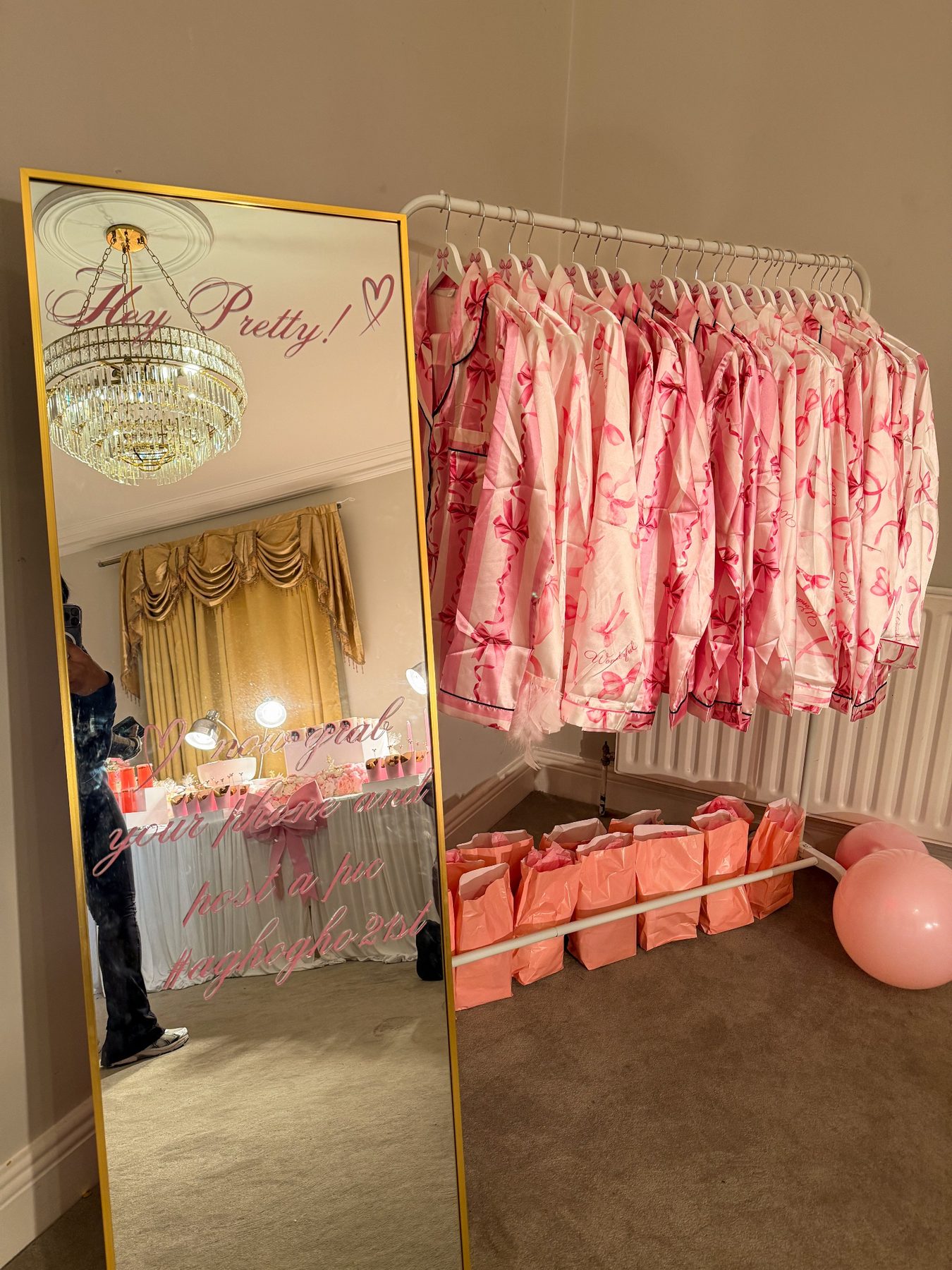 Gold mirror and a rail of pink pyjamas for a slumber party