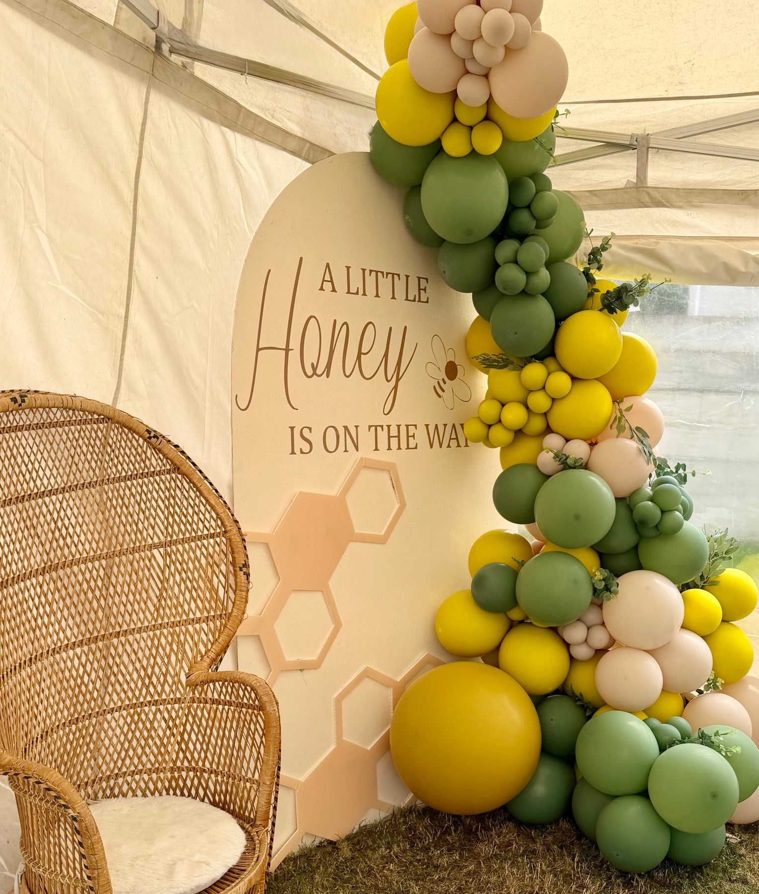 Baby shower balloon garland in sage, mustard and blush with a honeycomb backdrop